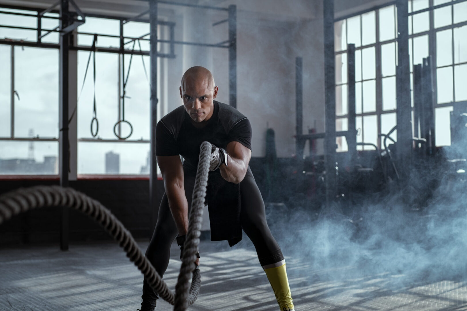 Bald,Athlete,Doing,Battle,Rope,Exercise,At,Crossfit,Gym.,Concentrated